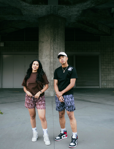 Our girl model wearing and representing our Monogram Logo Tee (Brown) combined with our Monogram Pattern Shorts (Brown) and our boy model wearing Monogram Logo Tee (Black), Monogram Pattern Shorts (Black) and our unreleased snapback hat.