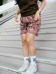 Our model wearing and representing our Monogram Logo Tee Brown combined with our Monogram Pattern Shorts (Brown) including the MADGRIND iconic socks.