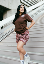 Load image into Gallery viewer, Our model wearing and representing our Monogram Logo Tee Brown combined with our Monogram Pattern Shorts (Brown) including the MADGRIND iconic socks.